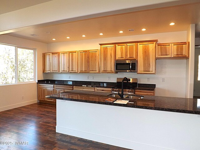 2759 Panther Cir, Overgaard, AZ 85933 - kitchen featuring appliances with stainless steel finishes, a sink, baseboards, dark wood-style floors, and brown cabinetry