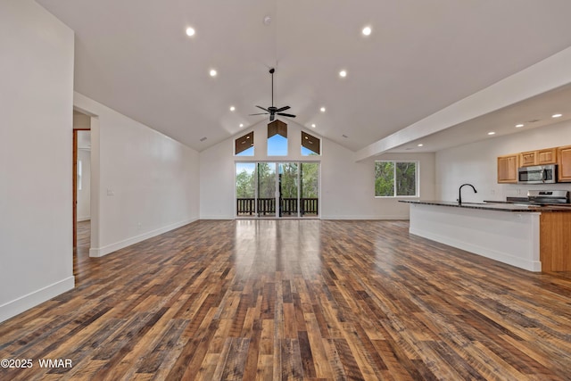 2759 Panther Cir, Overgaard, AZ 85933 - unfurnished living room with wood finished floors, ceiling fan, lofted ceiling, baseboards, and a sink