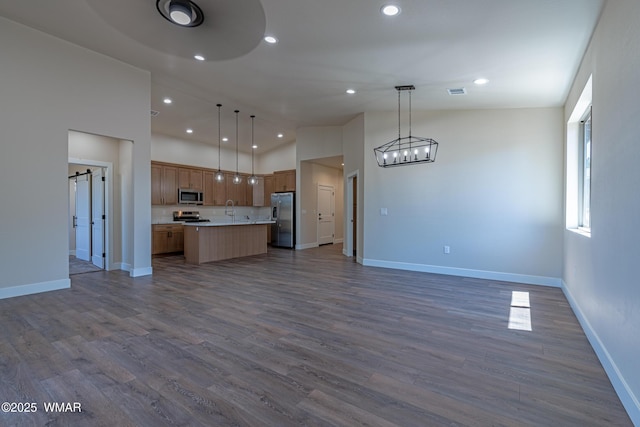 840 E Blue Jay Ln, Show Low, AZ 85901 - kitchen featuring appliances with stainless steel finishes, open floor plan, light countertops, recessed lighting, and a kitchen island with sink
