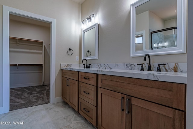 840 E Blue Jay Ln, Show Low, AZ 85901 - full bathroom featuring double vanity, marble finish flooring, a spacious closet, and a shower with shower door