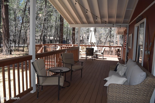 wooden terrace with outdoor dining area