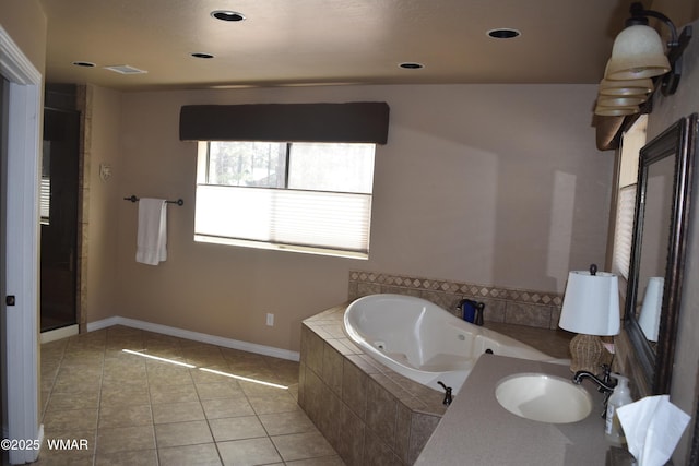 bathroom featuring a sink, tile patterned flooring, recessed lighting, baseboards, and a tub with jets