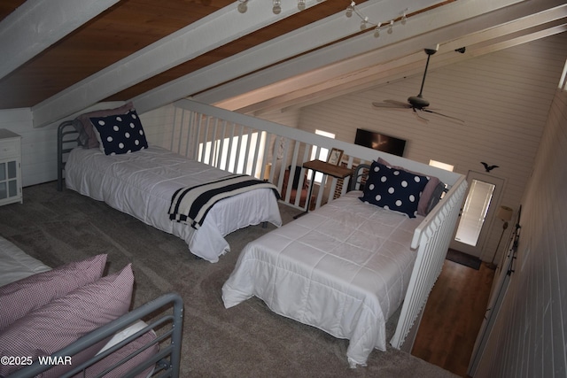 bedroom featuring carpet flooring and vaulted ceiling with beams