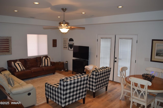 living room with french doors, recessed lighting, and light wood-style flooring