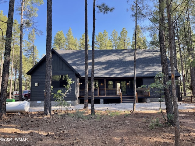 chalet / cabin with a shingled roof, crawl space, and board and batten siding