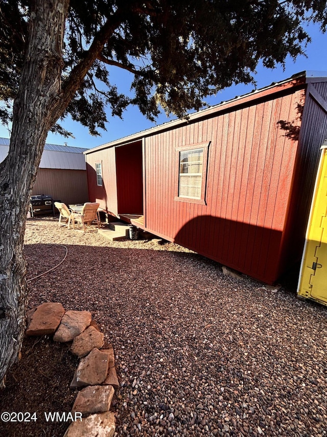 view of outbuilding featuring an outdoor fire pit