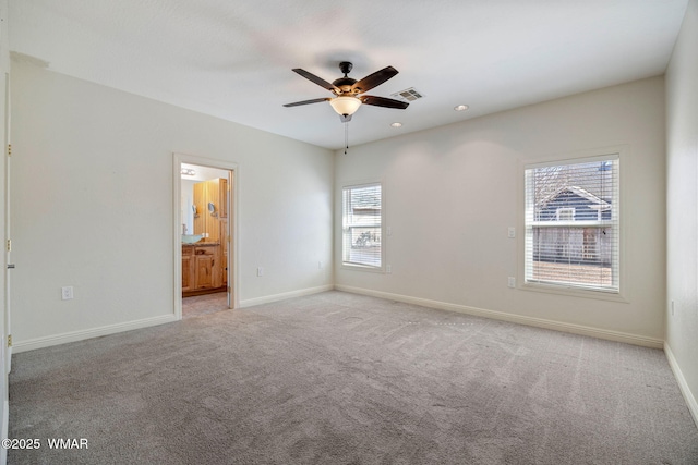 carpeted spare room featuring ceiling fan, recessed lighting, visible vents, and baseboards