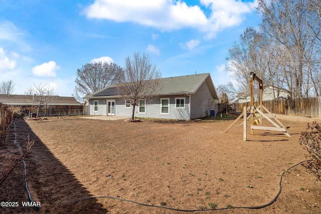 rear view of property with a fenced backyard and a patio