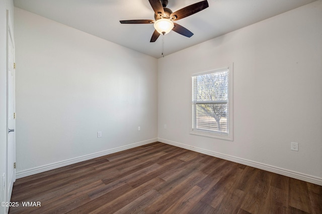 empty room with ceiling fan, baseboards, and dark wood-style flooring