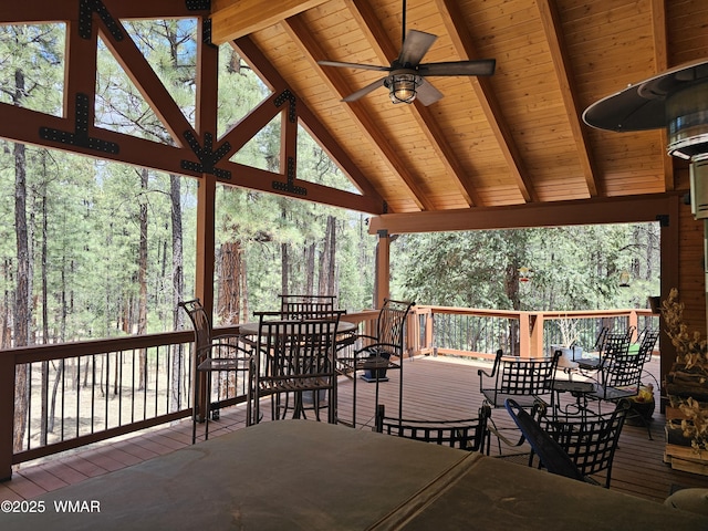 deck featuring outdoor dining area and a ceiling fan