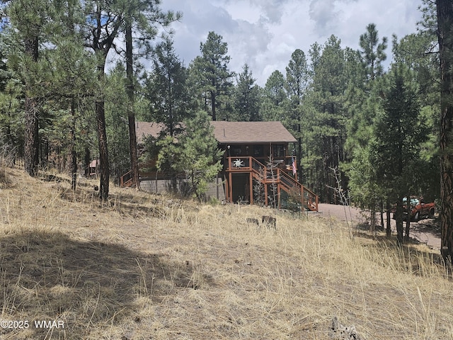 exterior space featuring stairway and a wooden deck