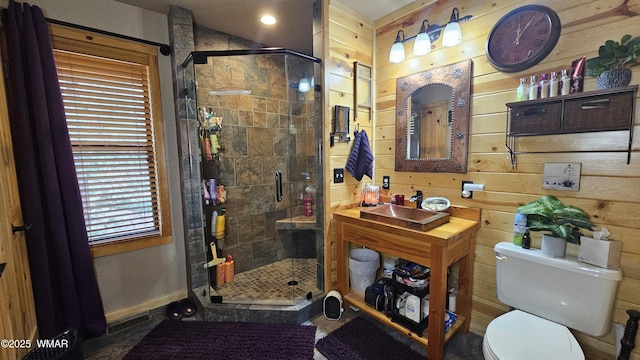 full bath featuring toilet, baseboards, a shower stall, and wooden walls