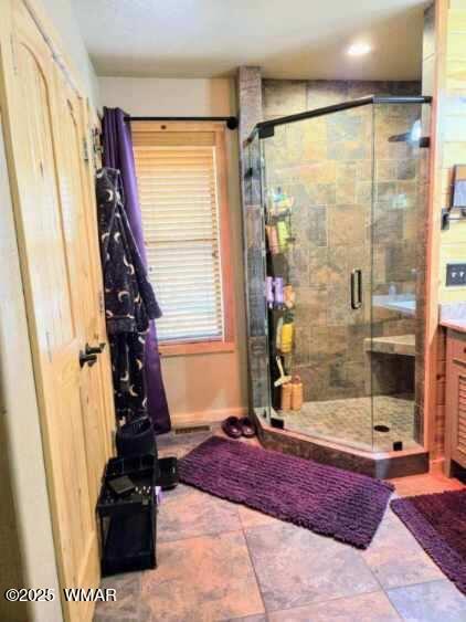 bathroom with vanity and a shower stall