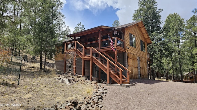 back of property with stairway and a wooden deck