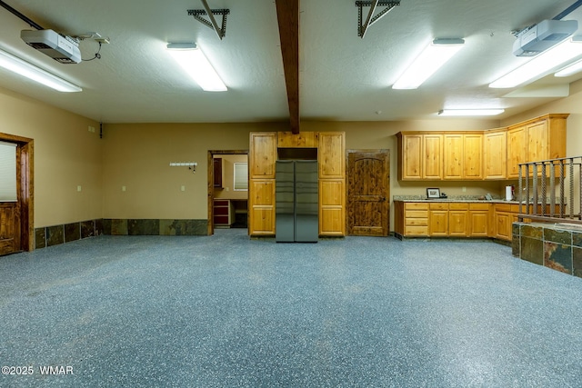 interior space with beamed ceiling and light countertops