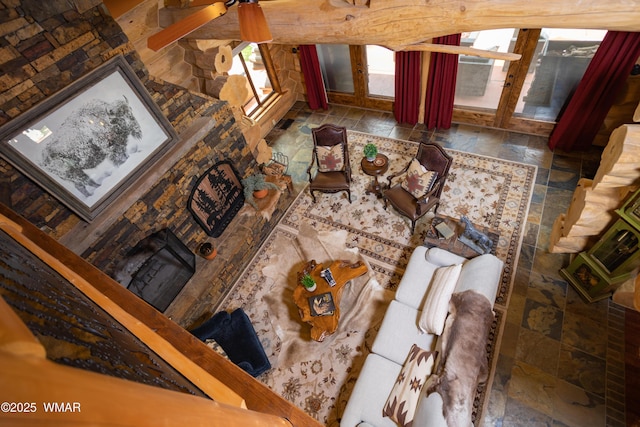 living area featuring a fireplace and stone tile flooring