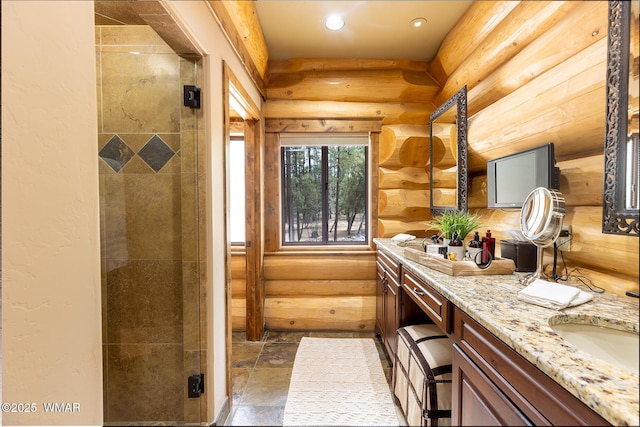 full bath with log walls, recessed lighting, double vanity, and a stall shower