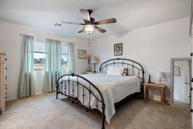 bedroom with ceiling fan, visible vents, and light colored carpet