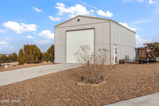 garage featuring concrete driveway