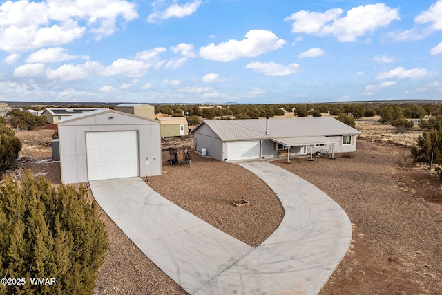 single story home featuring a garage and an outdoor structure