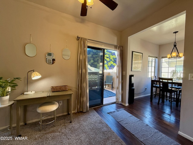 doorway to outside with ceiling fan, dark wood-type flooring, and baseboards