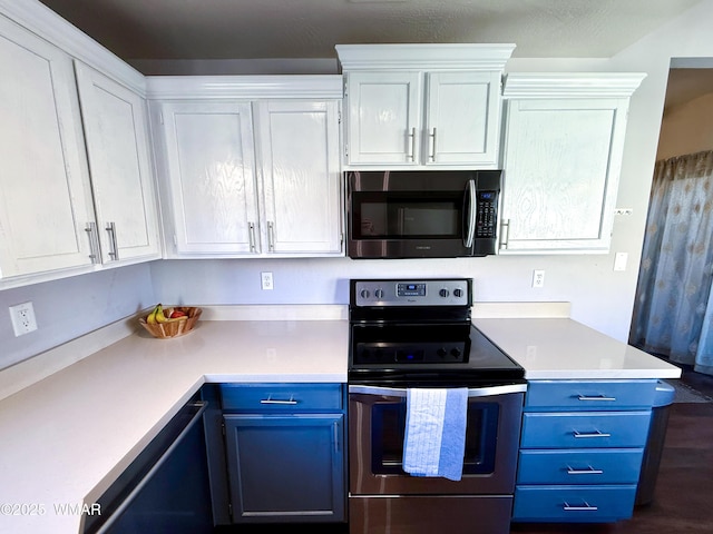 kitchen with light countertops, appliances with stainless steel finishes, blue cabinetry, and white cabinets