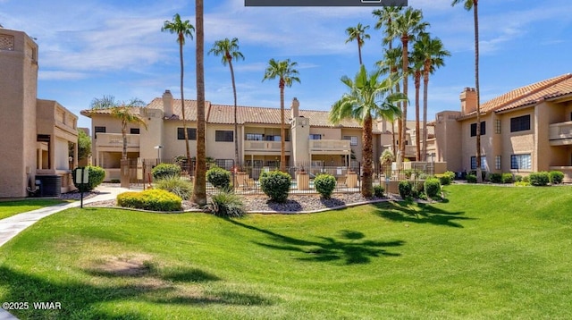 view of property's community featuring a residential view and a yard