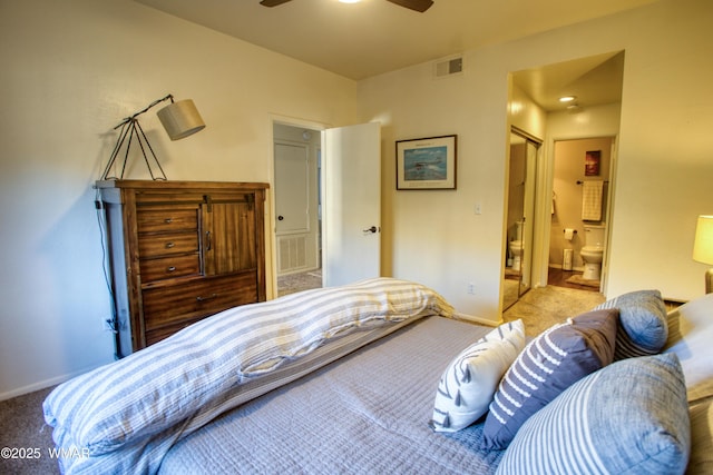 bedroom with baseboards, connected bathroom, visible vents, and light colored carpet