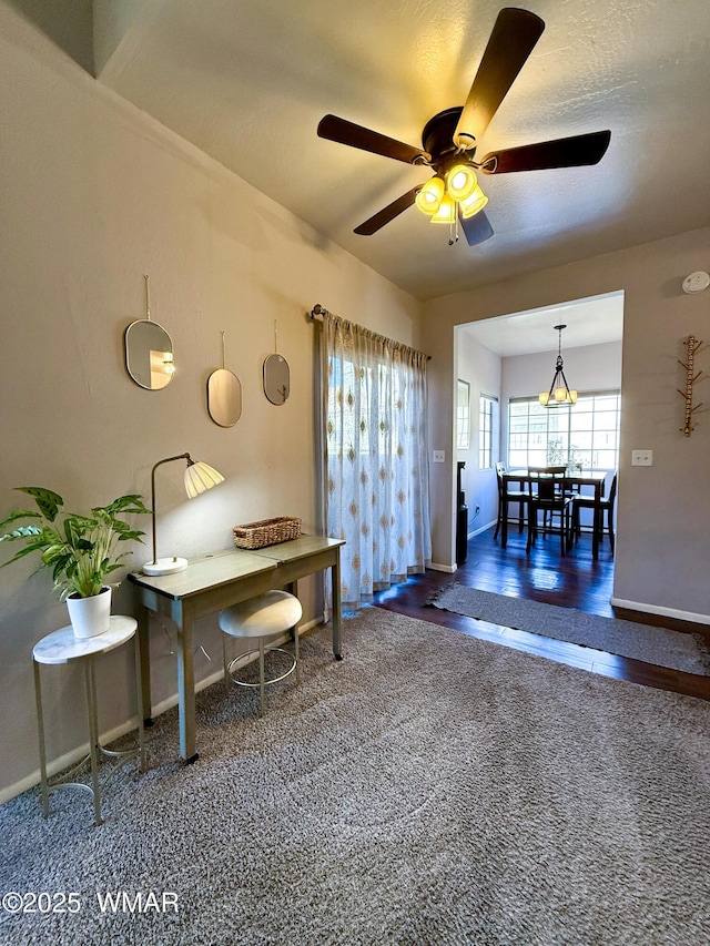 dining area with dark carpet, a ceiling fan, and baseboards