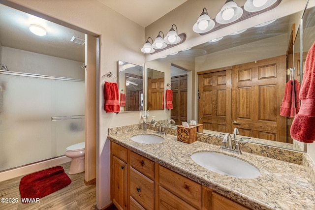1761 N Bison Ct, Show Low, AZ 85901 - bathroom with wood finished floors, double vanity, and a shower stall