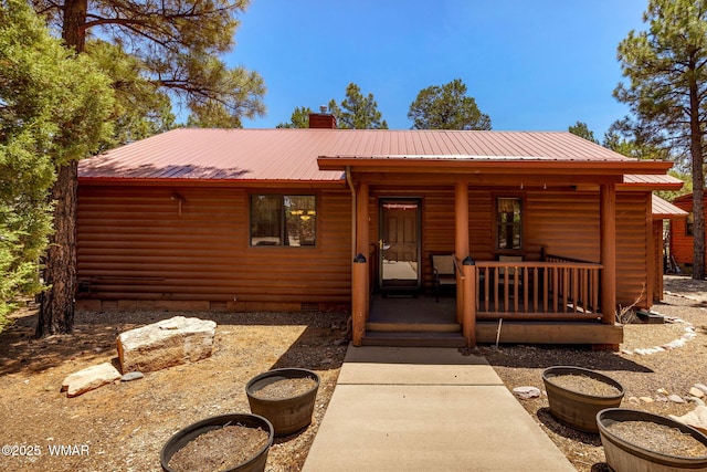 1761 N Bison Ct, Show Low, AZ 85901 - chalet / cabin featuring a chimney, a porch, crawl space, and log veneer siding