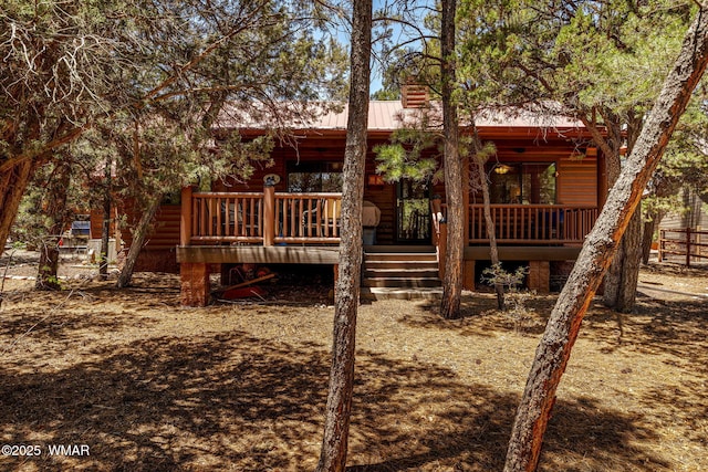 1761 N Bison Ct, Show Low, AZ 85901 - rear view of house with faux log siding, a metal roof, and stairs