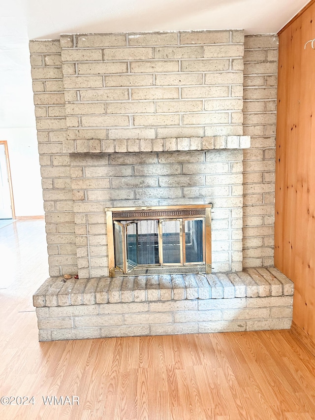 room details featuring a fireplace and wood finished floors