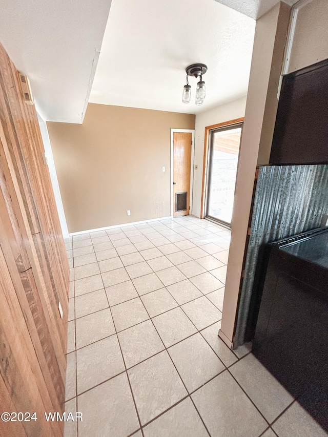 spare room with light tile patterned floors