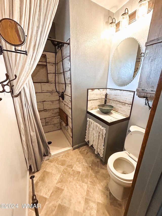 full bath featuring a textured wall, a shower stall, toilet, and vanity