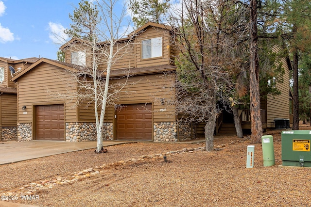 view of front facade featuring stone siding and concrete driveway