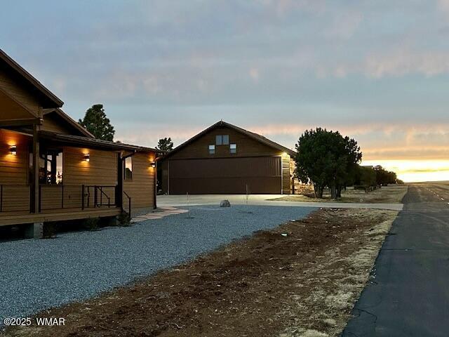 2344 Hellcat Cir, Overgaard, AZ 85933 - property exterior at dusk with a deck