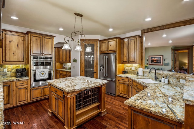 4040 W Ninebark Ln, Show Low, AZ 85901 - kitchen with stainless steel appliances, brown cabinetry, dark wood finished floors, and recessed lighting