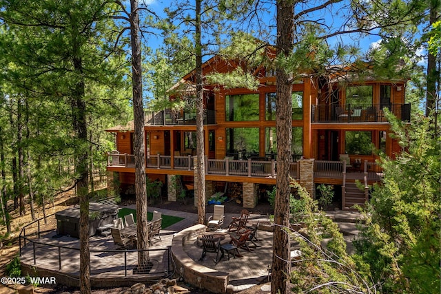 4040 W Ninebark Ln, Show Low, AZ 85901 - rear view of house featuring a hot tub, a balcony, a patio, an outdoor fire pit, and stairway