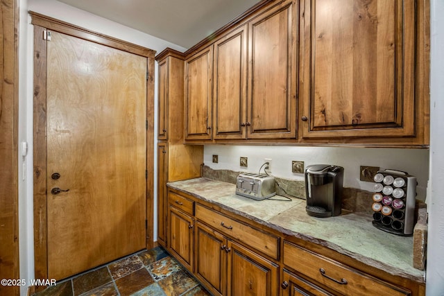 4040 W Ninebark Ln, Show Low, AZ 85901 - kitchen featuring brown cabinets, stone finish floors, and light countertops