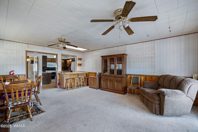 367 S Main St, Eagar, AZ 85925 - living room with light carpet, ceiling fan, and wallpapered walls