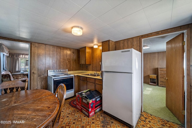367 S Main St, Eagar, AZ 85925 - kitchen with white appliances, wood walls, brown cabinets, and light countertops