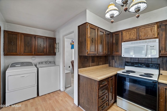 367 S Main St, Eagar, AZ 85925 - kitchen featuring range with electric stovetop, white microwave, washer and dryer, light countertops, and a chandelier