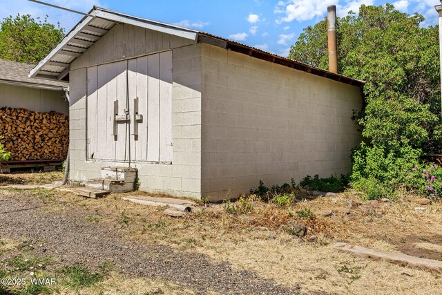 367 S Main St, Eagar, AZ 85925 - view of side of home with concrete block siding and a storage shed