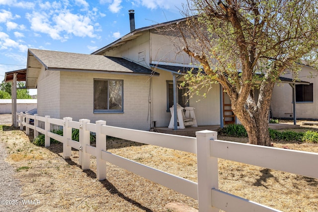 367 S Main St, Eagar, AZ 85925 - view of front of home featuring a fenced front yard, brick siding, and roof with shingles