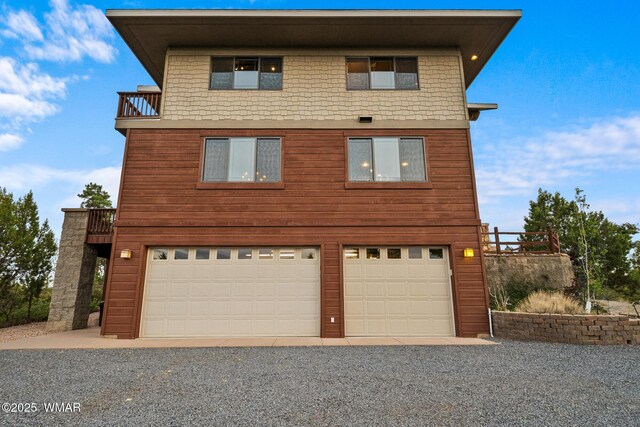 1511 S Canyon Ridge Trl, Show Low, AZ 85901 - view of front of house with a garage, driveway, and a balcony
