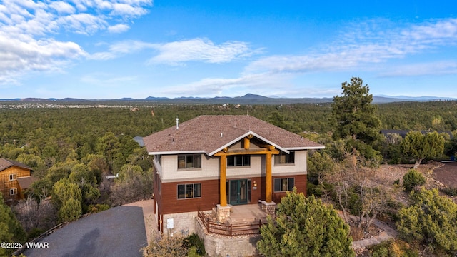 1511 S Canyon Ridge Trl, Show Low, AZ 85901 - view of front of home featuring a view of trees, a mountain view, and gravel driveway