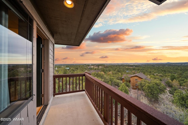 1511 S Canyon Ridge Trl, Show Low, AZ 85901 - balcony at dusk featuring a wooded view