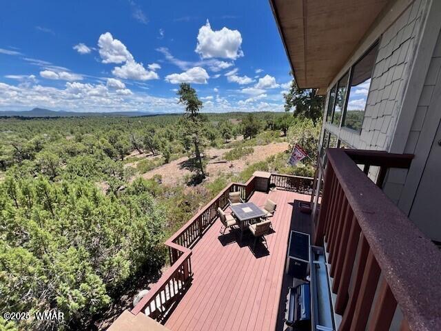 1511 S Canyon Ridge Trl, Show Low, AZ 85901 - wooden deck with outdoor dining space and a forest view