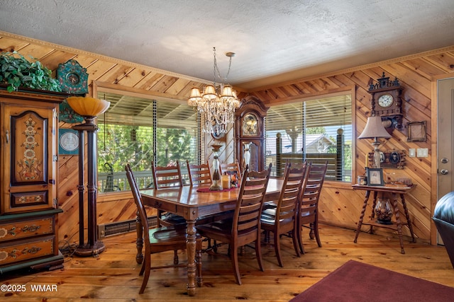 327 W 10th St, Eagar, AZ 85925 - dining area with wood walls, a notable chandelier, plenty of natural light, and light wood-type flooring